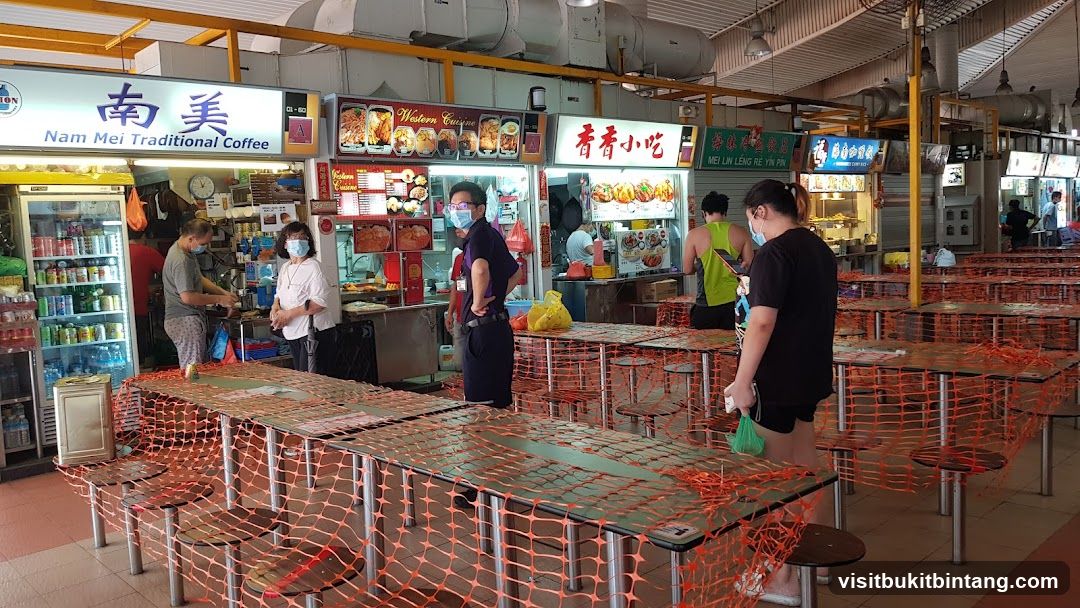 Food court with tables covered in orange netting