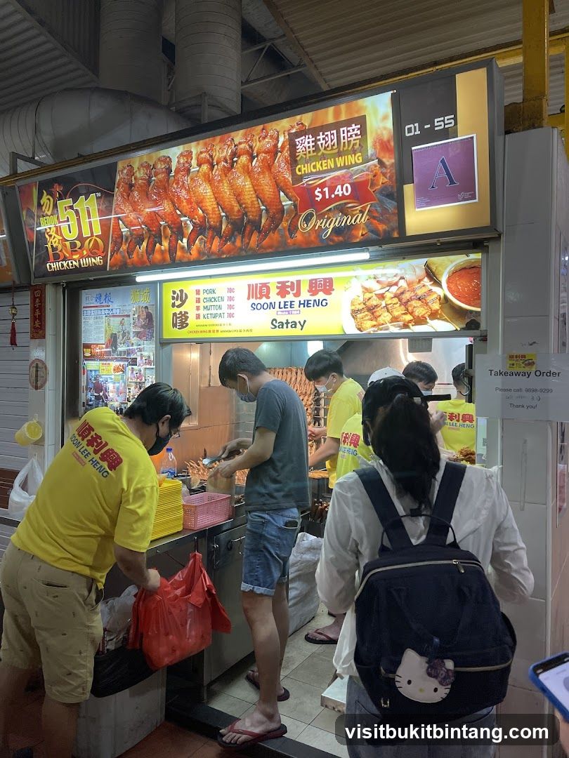 Food stall with chicken wings and satay