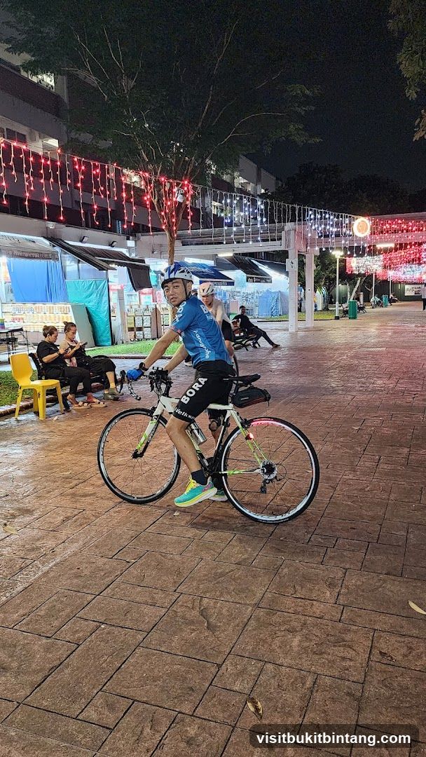 Cyclist in a night market