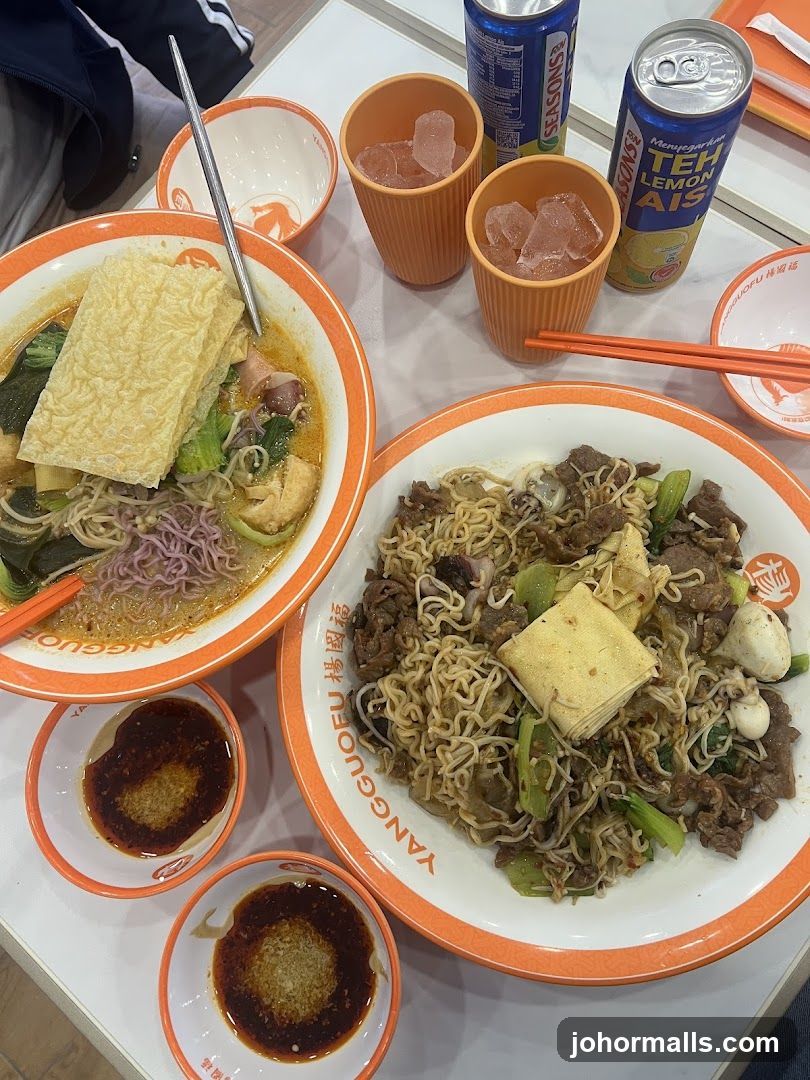 Dining table with noodle dishes and beverages