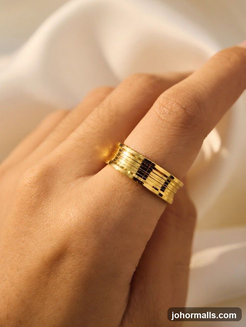 Hand wearing gold ring