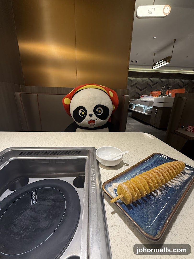 Panda Plush Toy at Restaurant Table