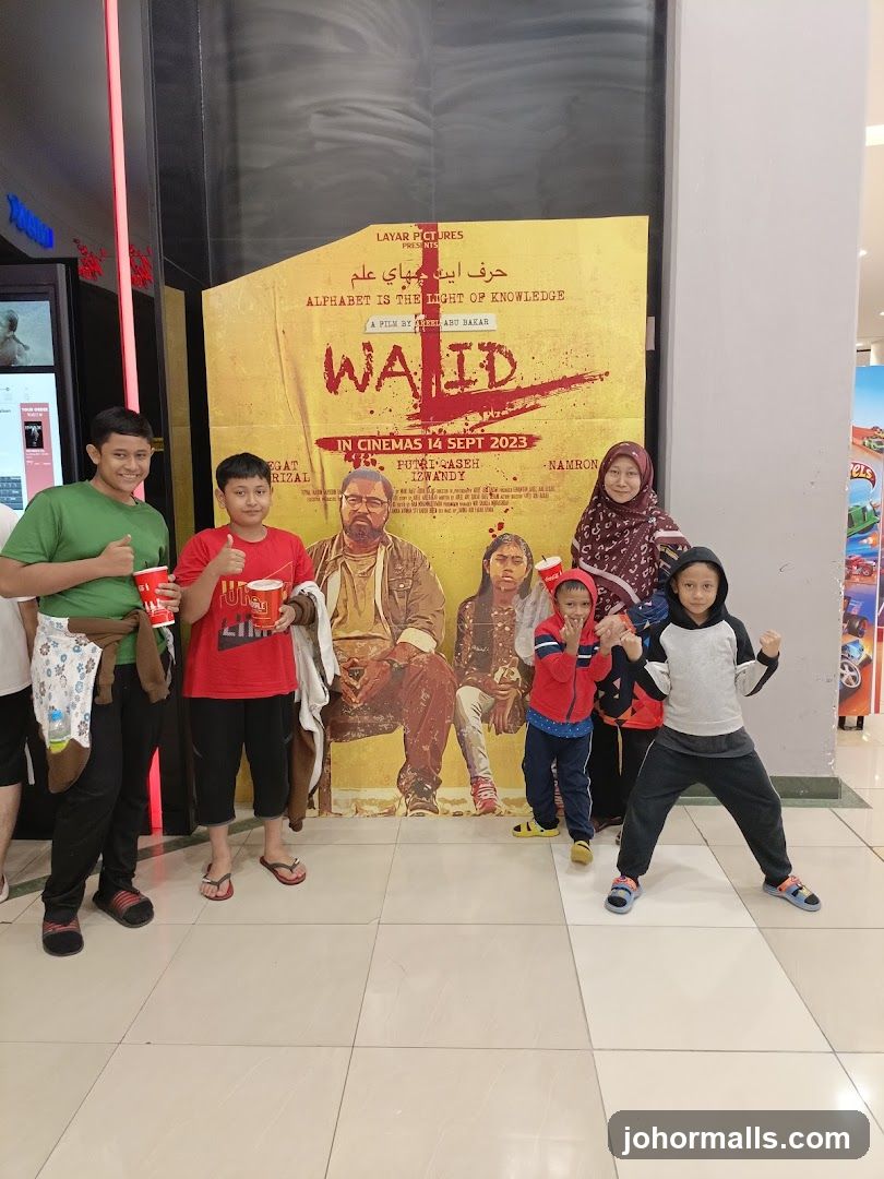 Family Poses in Front of Movie Poster
