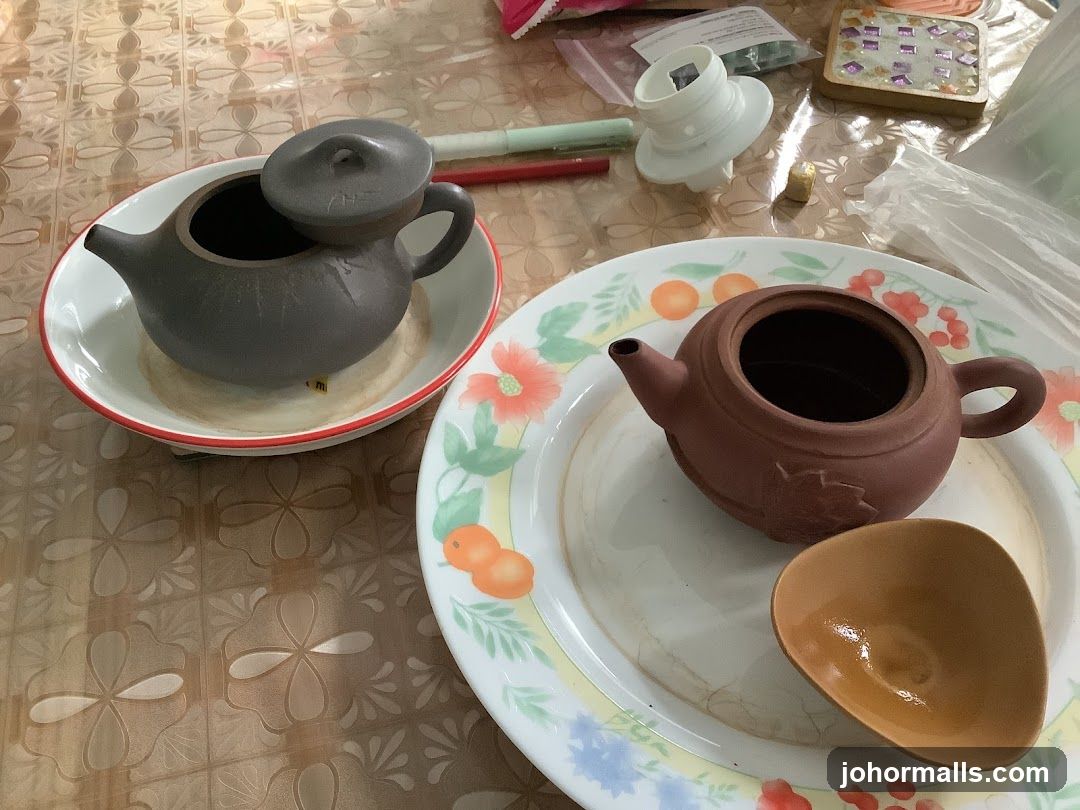 Two teapots on plates