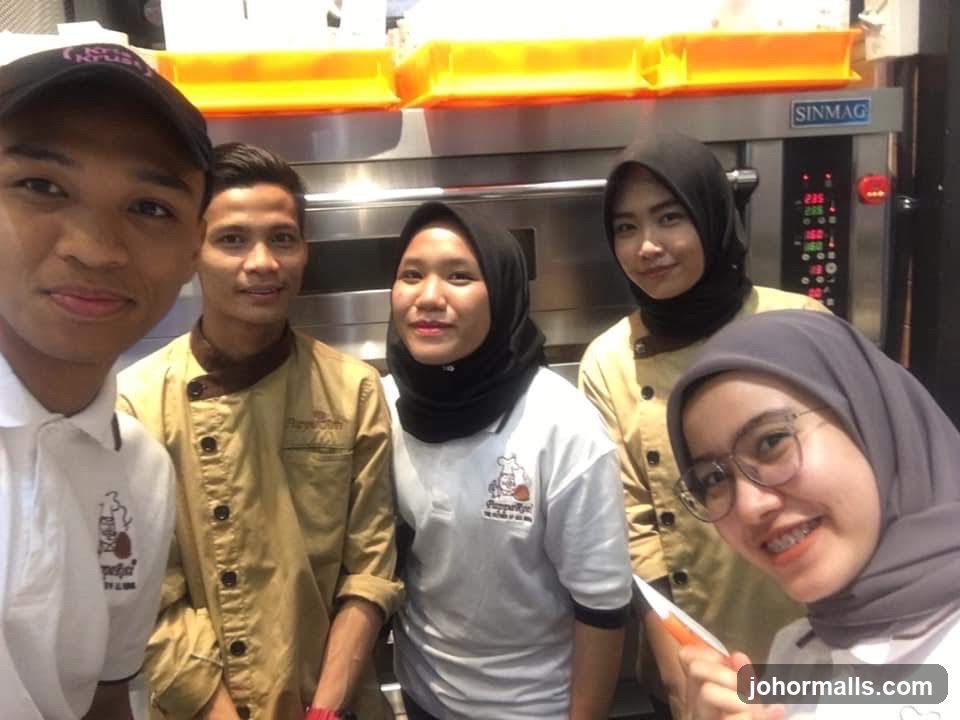 Bakery Staff Posing in Front of Ovens