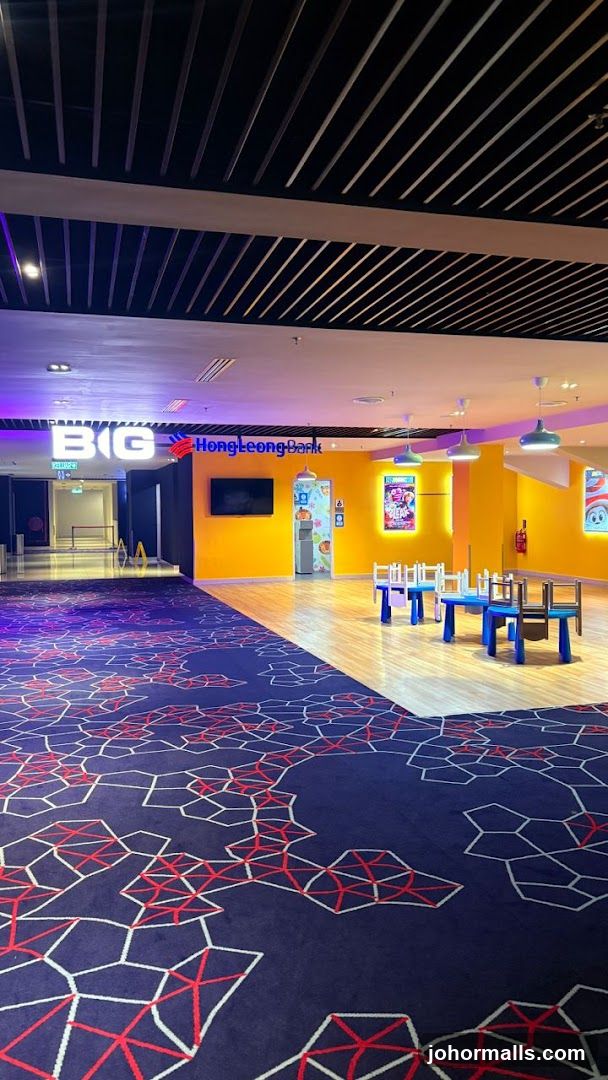 Interior of a brightly lit space with patterned carpet and yellow walls