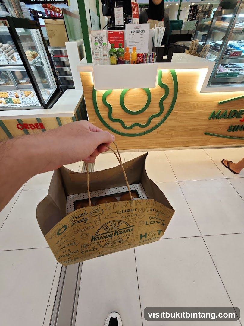 Customer holding Krispy Kreme bag in store
