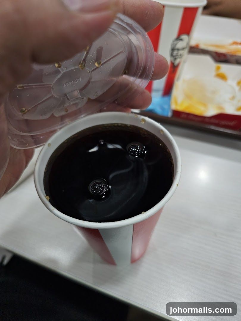 Hand holding drink cup with lid