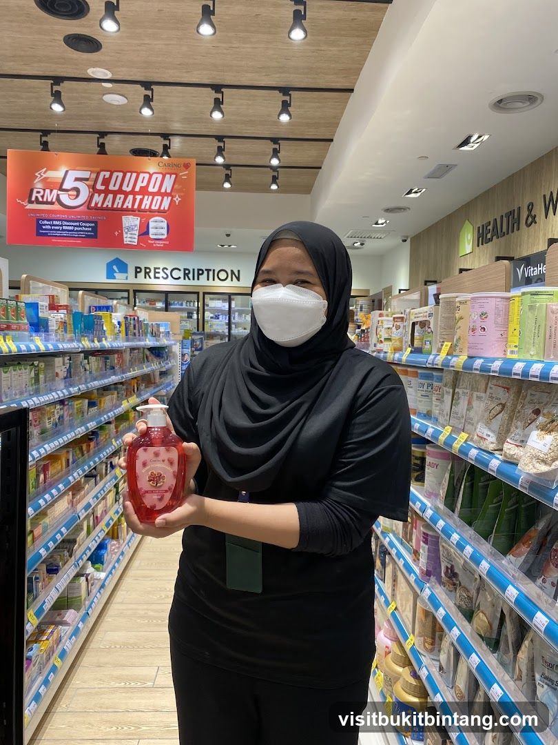 Woman holding a bottle of hand soap in a pharmacy