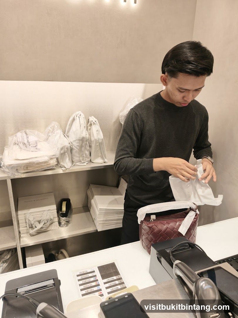 Sales associate packaging a handbag