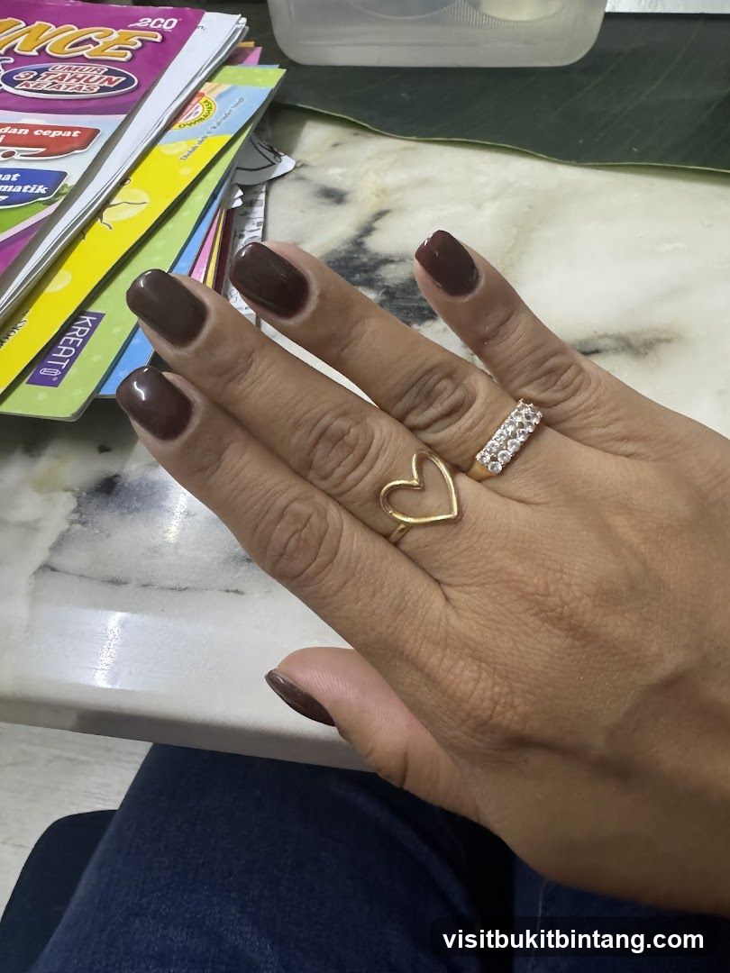Woman's Hand with Rings and Dark Nail Polish