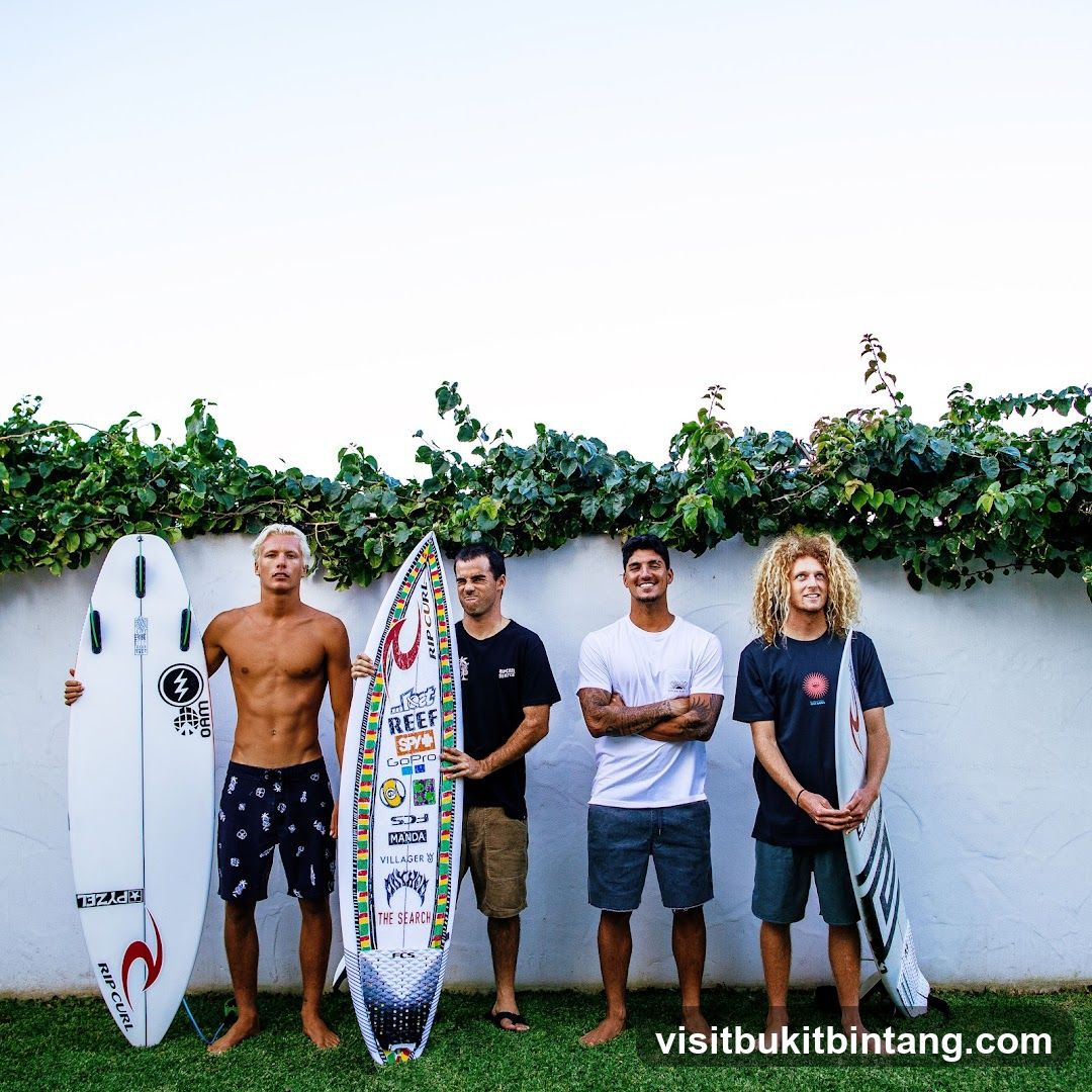 Four Surfers Posing with Surfboards