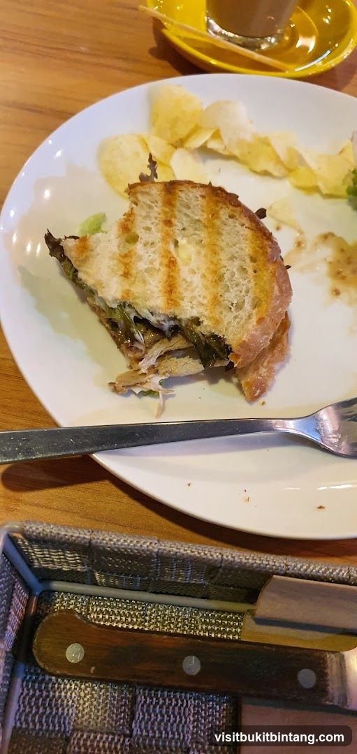 Half-eaten sandwich with chips