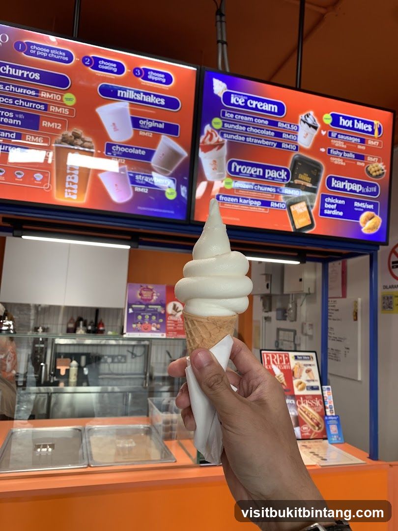 Person holding an ice cream cone in front of a menu board