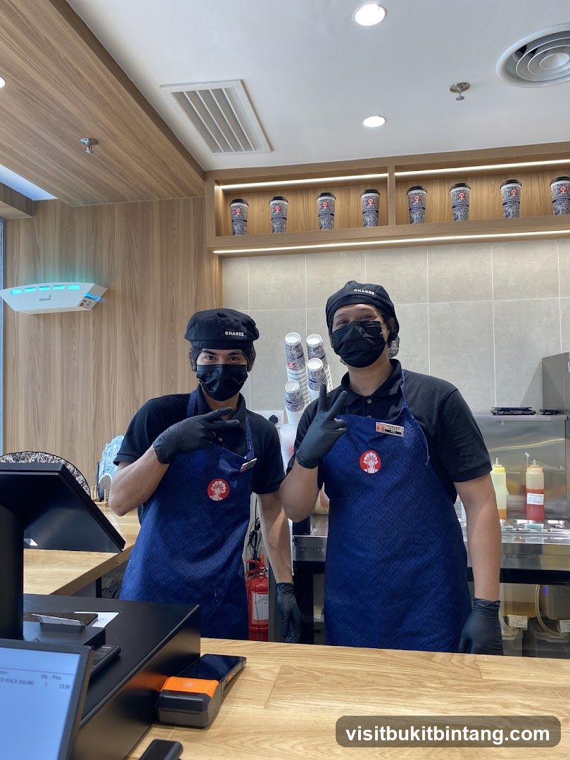 Two staff members behind a counter