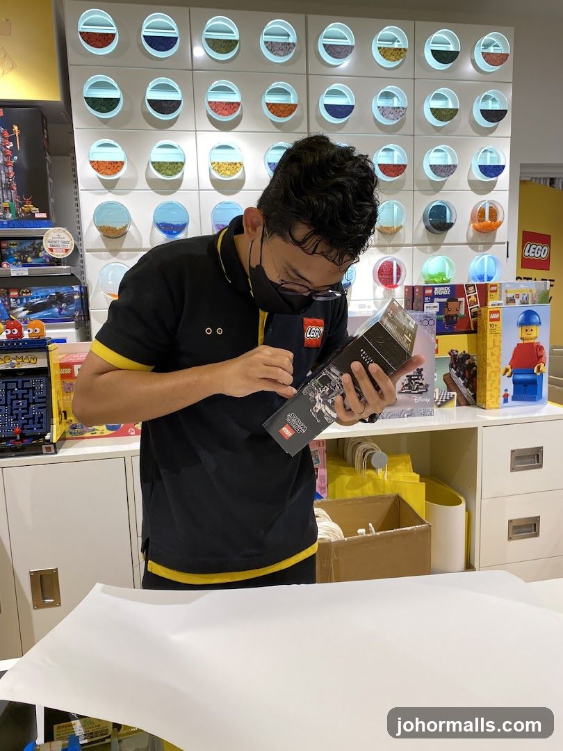 LEGO Store Employee Examining a Product Manual