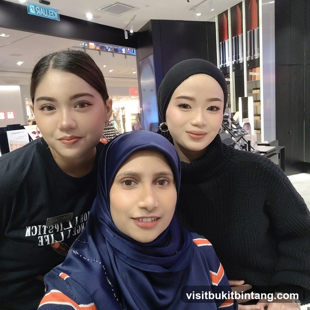 Three women posing for a selfie in a makeup store