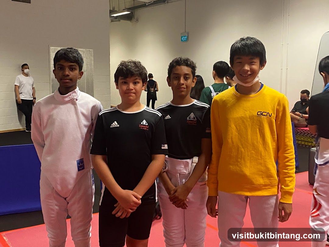 Four young fencers posing for a photo