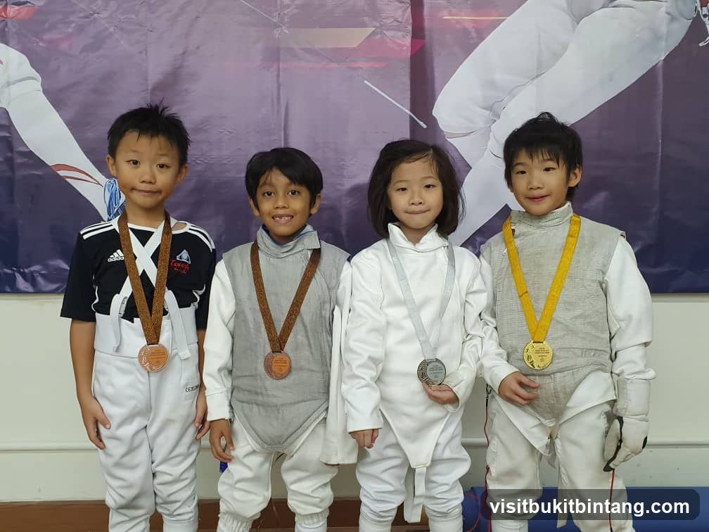 Four Children in Fencing Gear with Medals