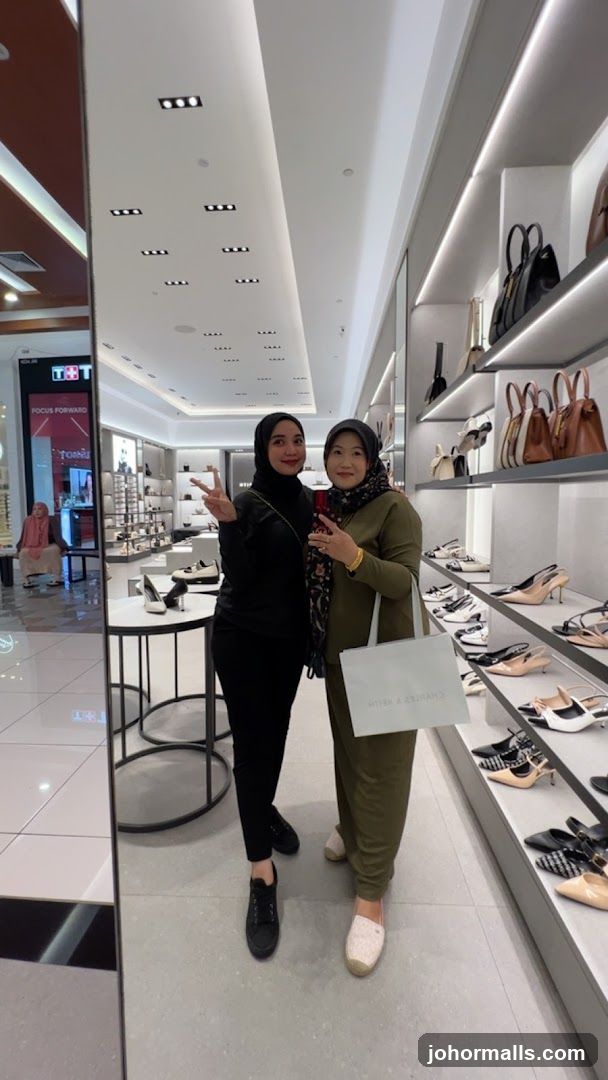 Two women posing in a shoe store