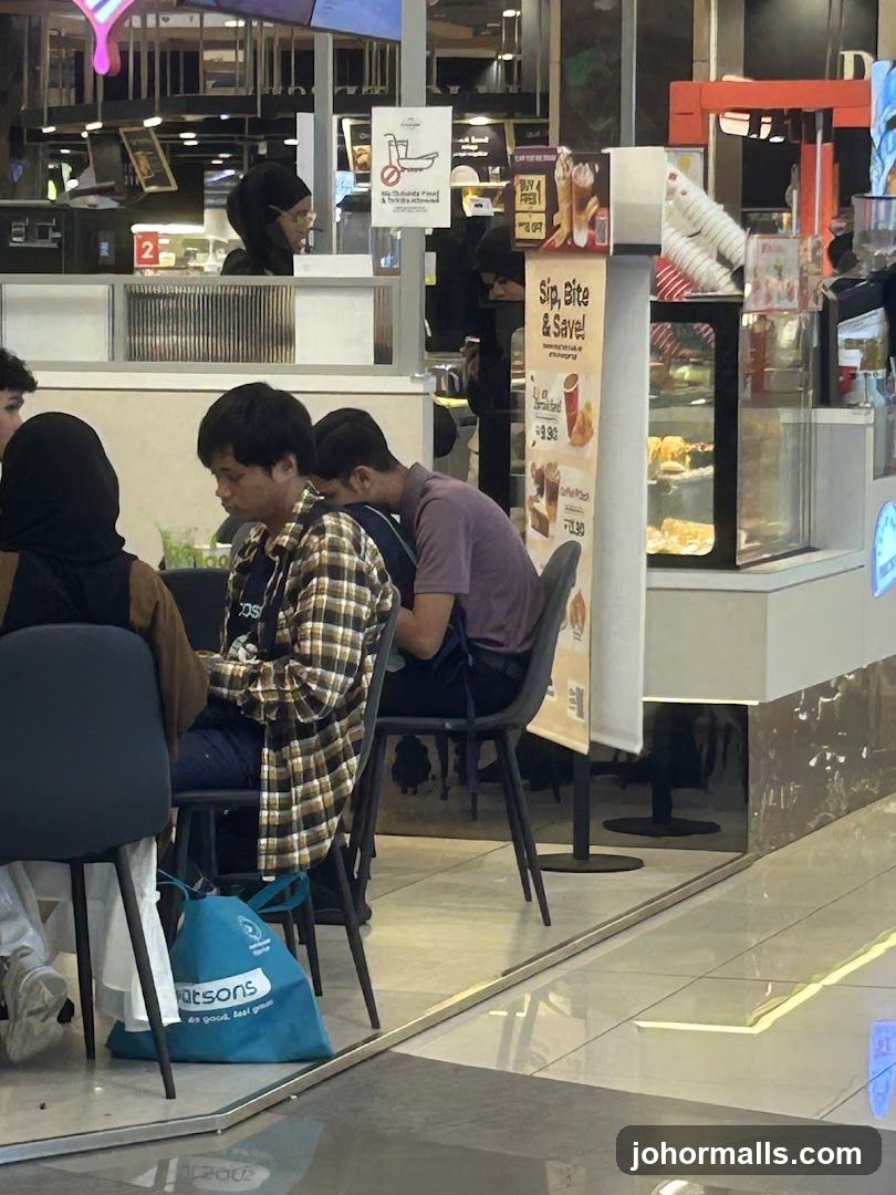 People sitting at tables in a cafe