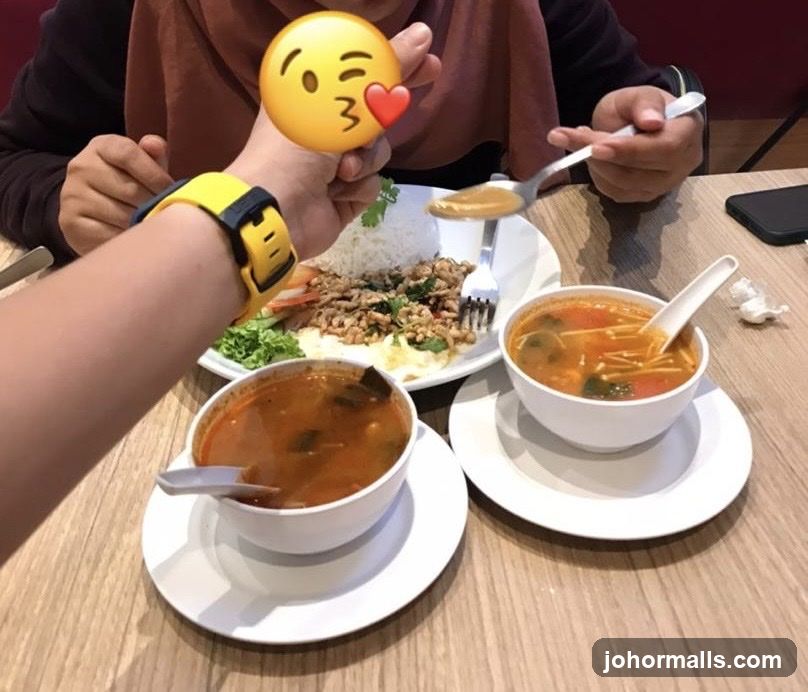 Two bowls of soup and a plate of food