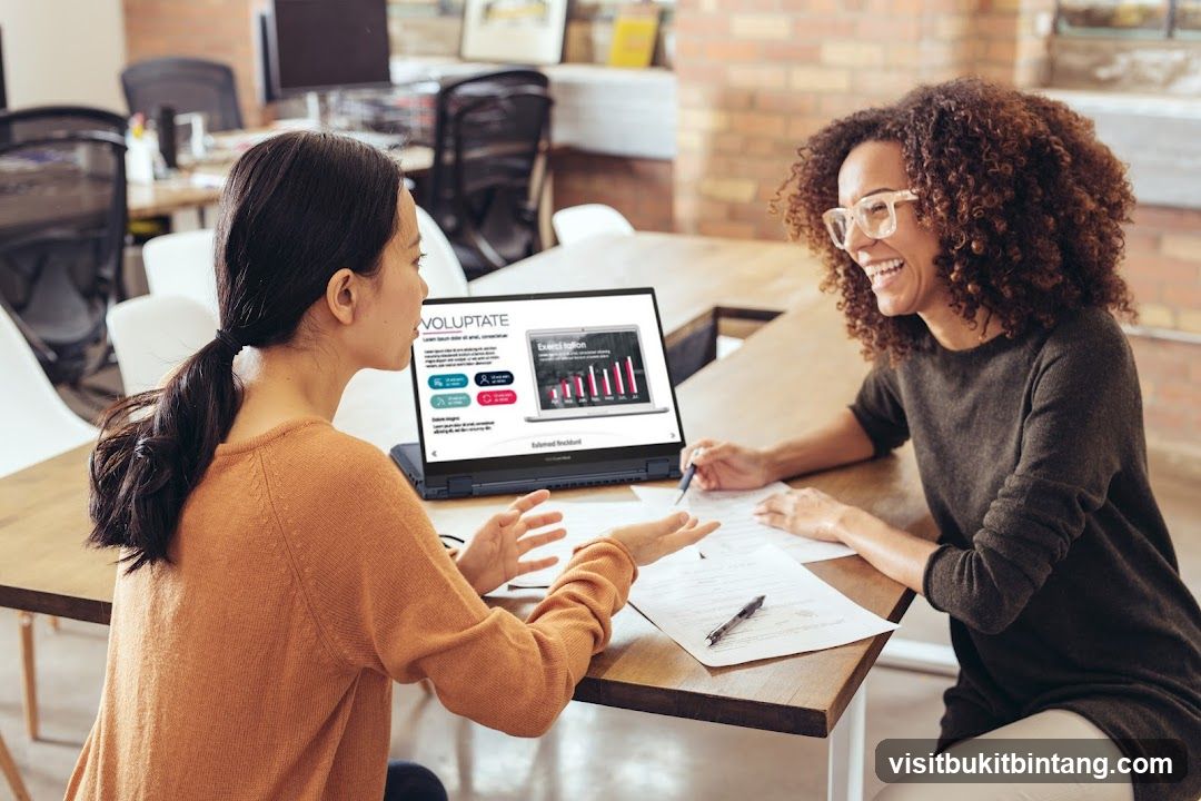 Two women in an office discussing a presentation