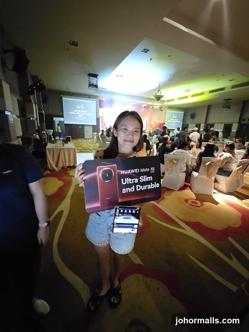 Woman holding Huawei Mate X6 promotional sign and phone