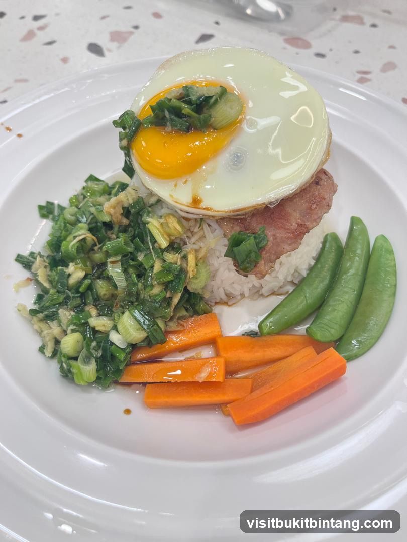 Rice dish with fried egg and vegetables