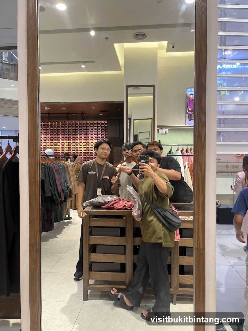 Group taking a mirror selfie in a clothing store