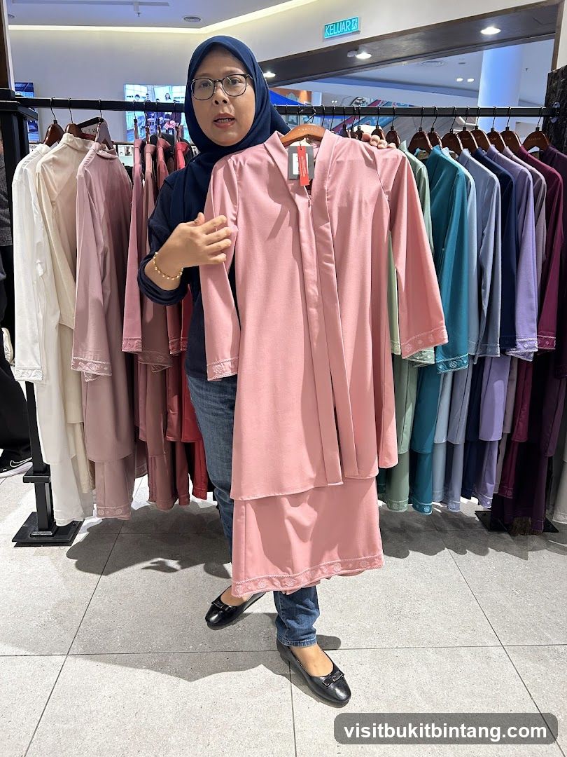 Woman holding a pink outfit in a clothing store