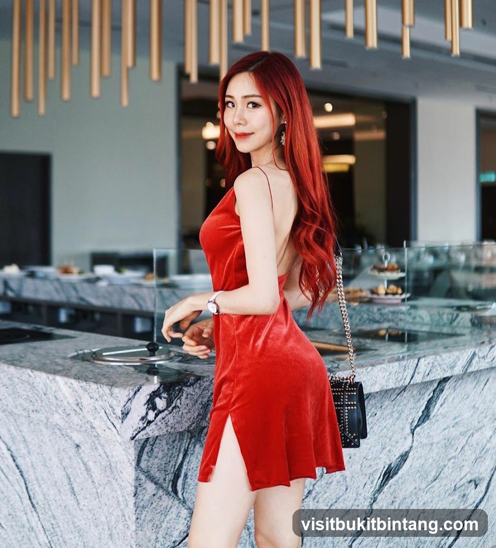 Woman in red dress posing in a restaurant