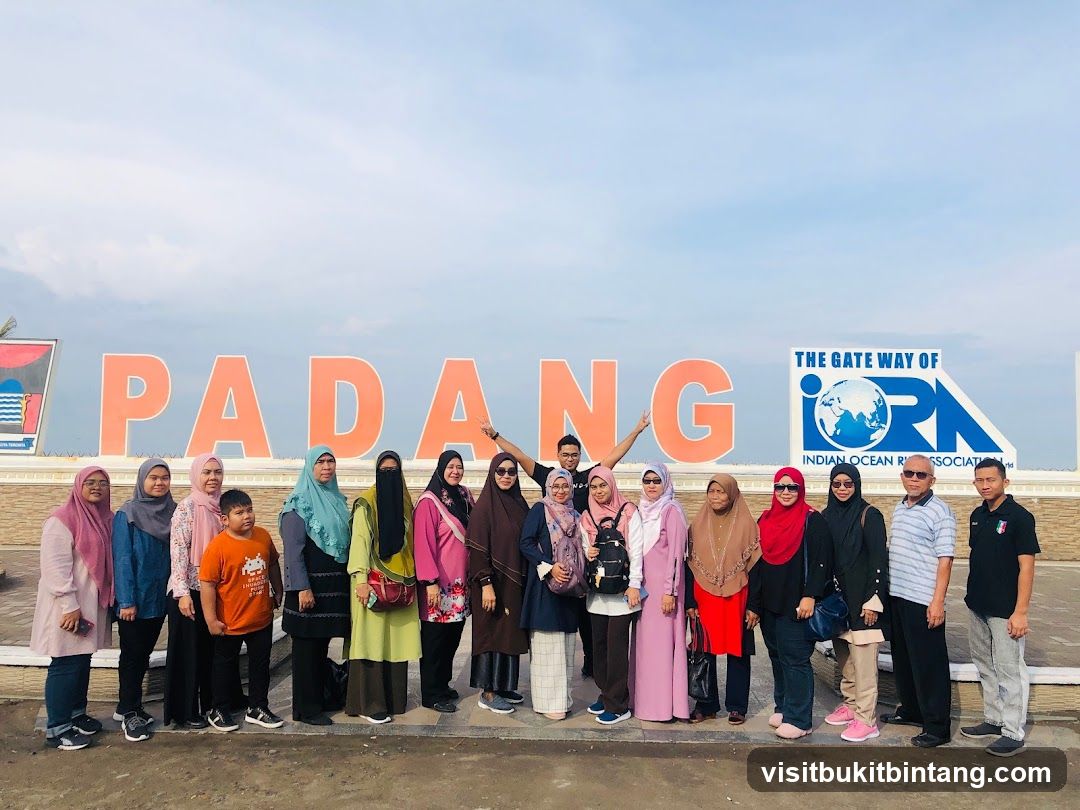 Group Poses in Front of Large Signage