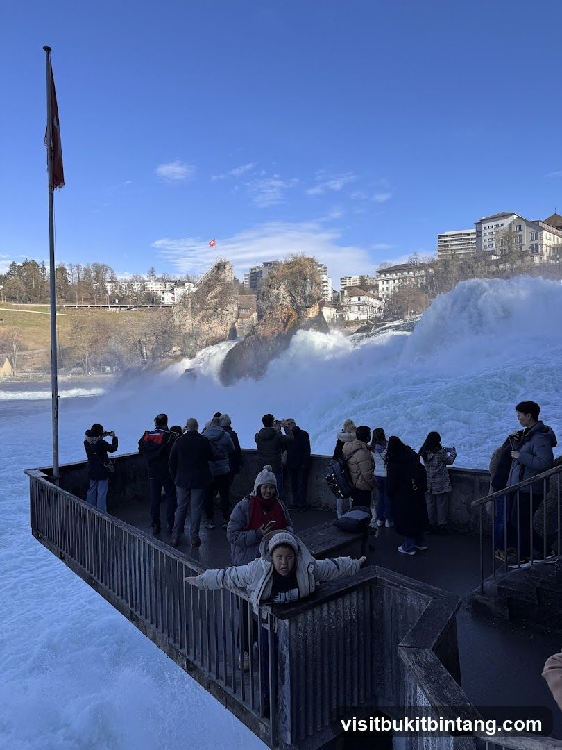 Tourists at a Waterfall Viewing Platform