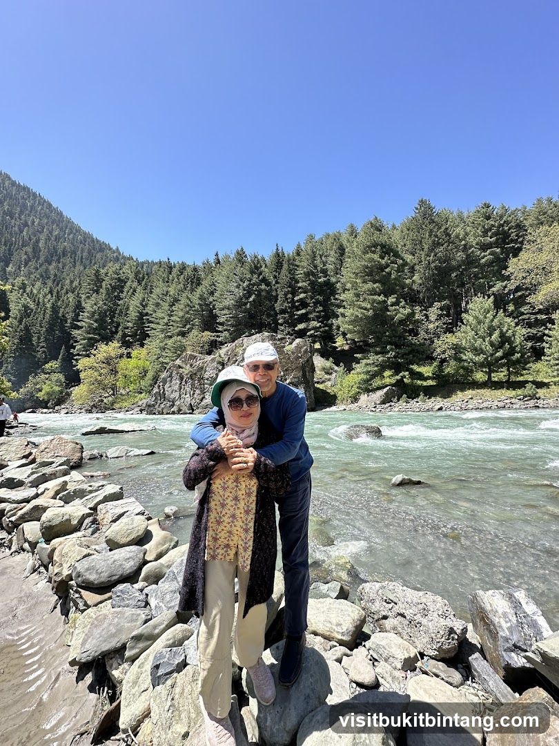 Couple posing by a river