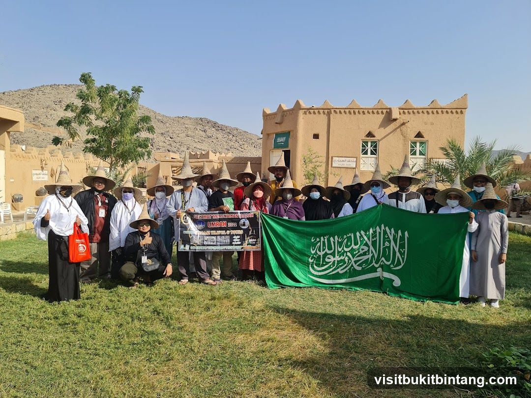 Group Poses with Saudi Flag