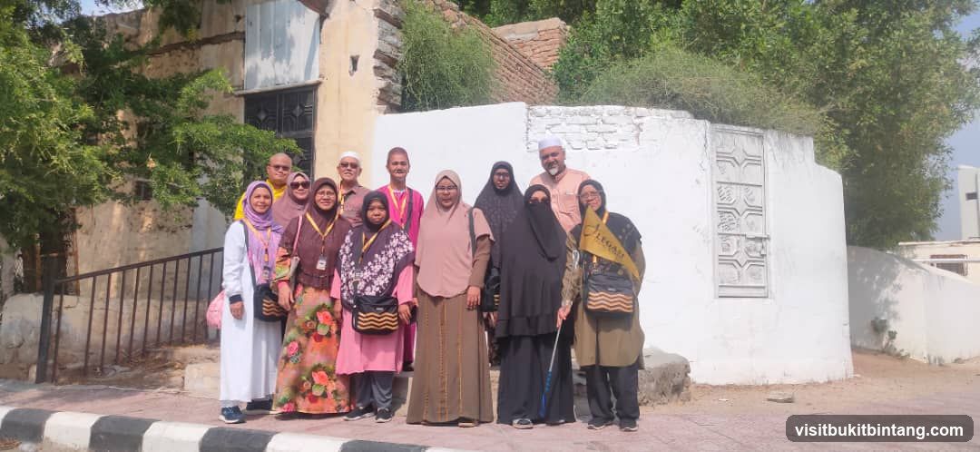 Group posing in front of old buildings