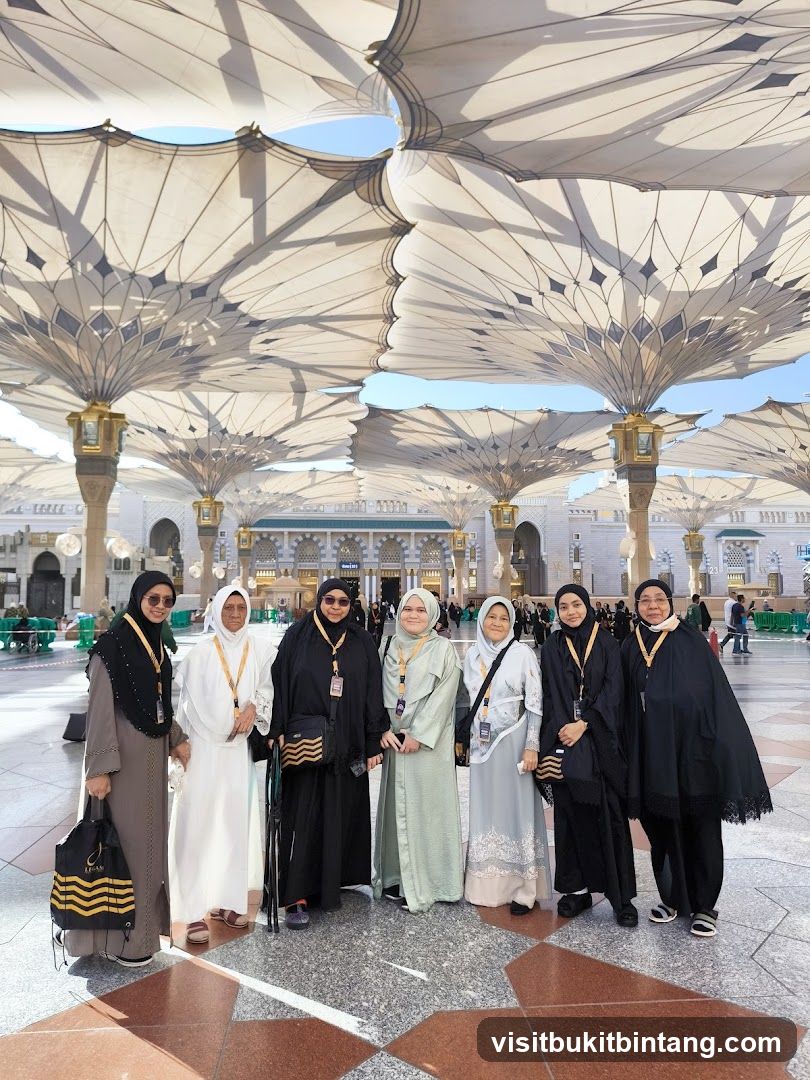 Group of women posing under large umbrellas