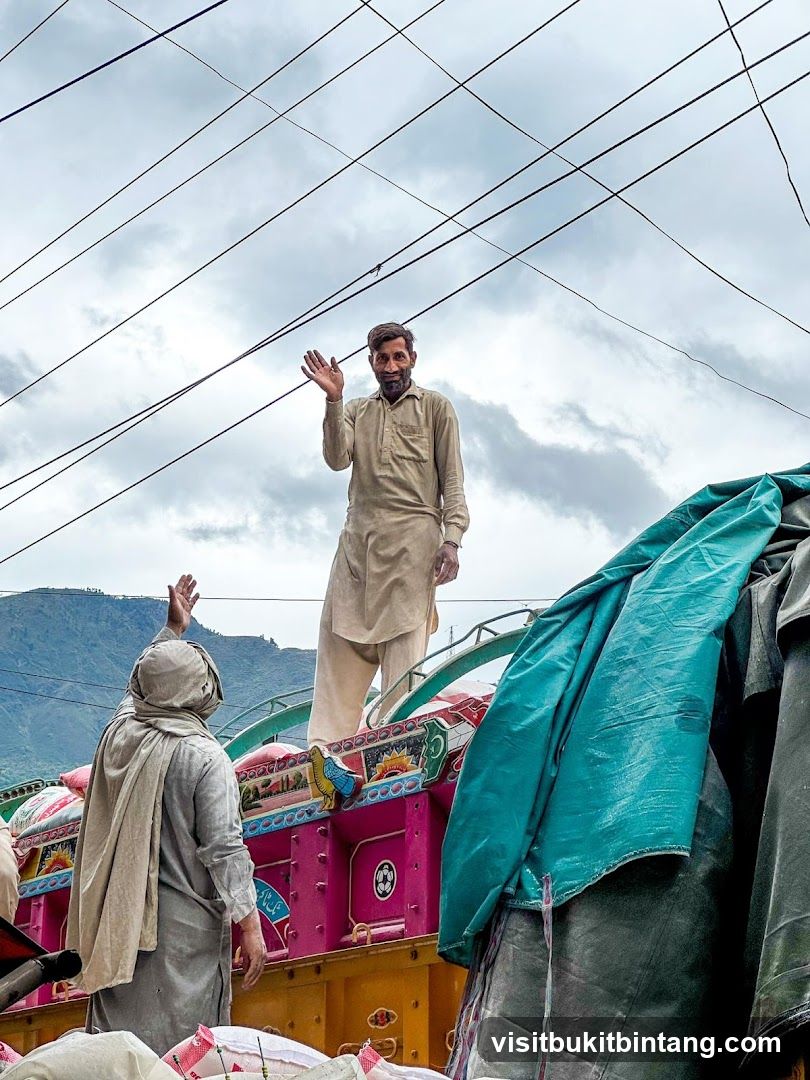 Men waving from a truck