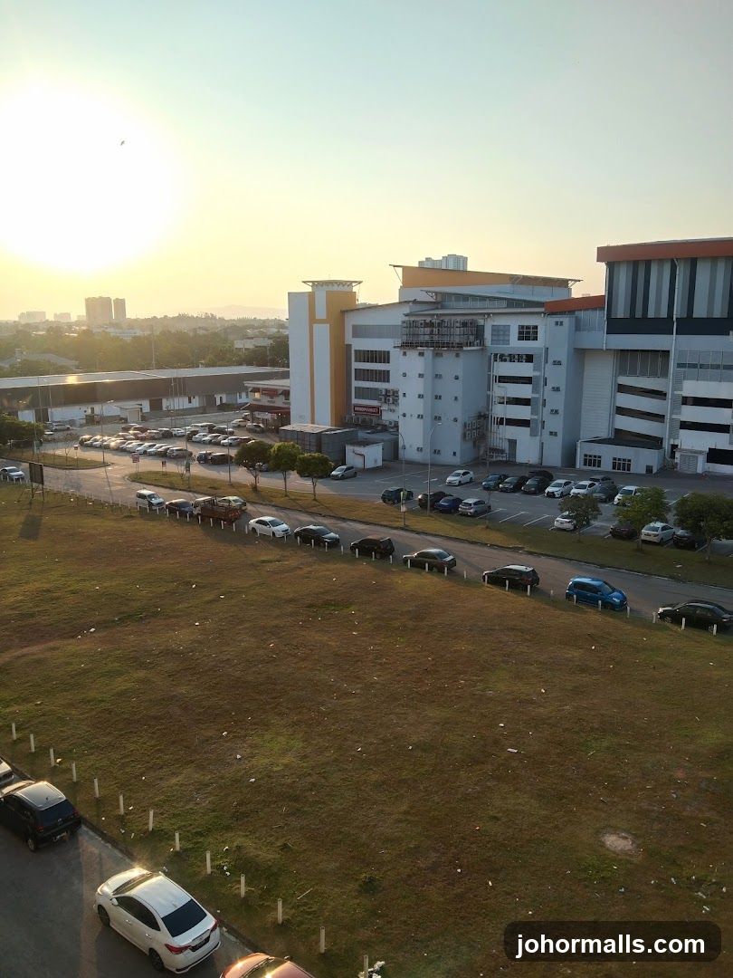 Cars parked in a lot with buildings in the background