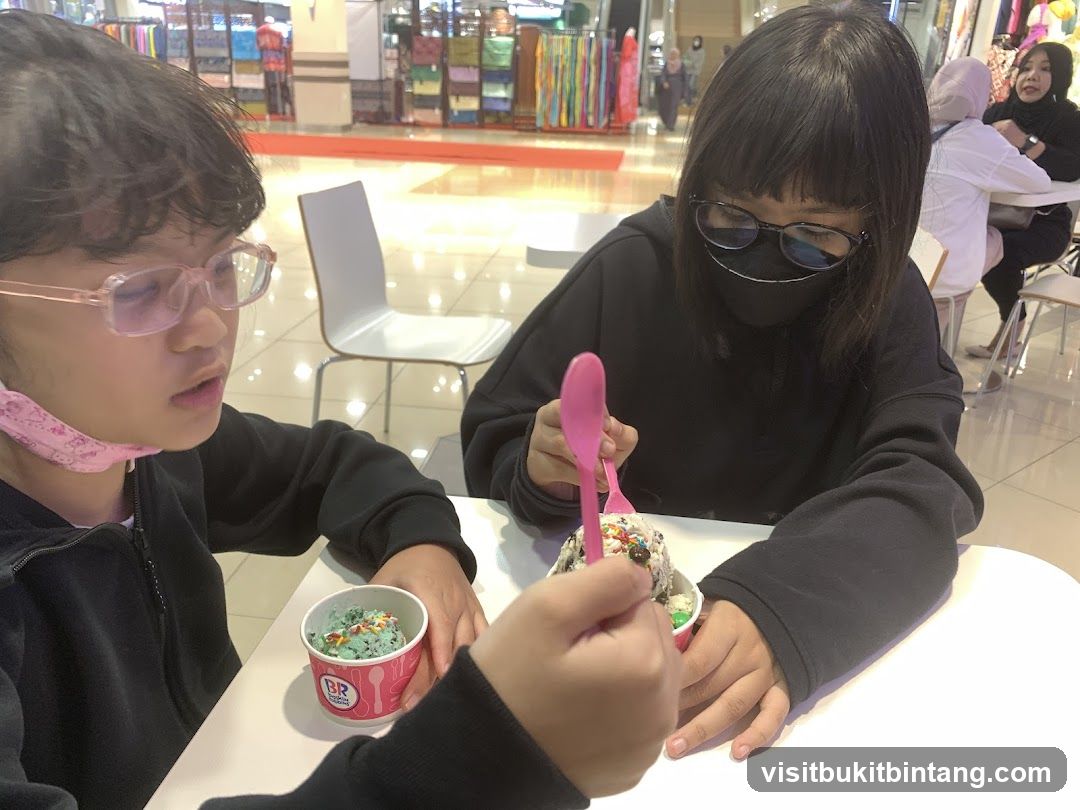 Two girls eating ice cream