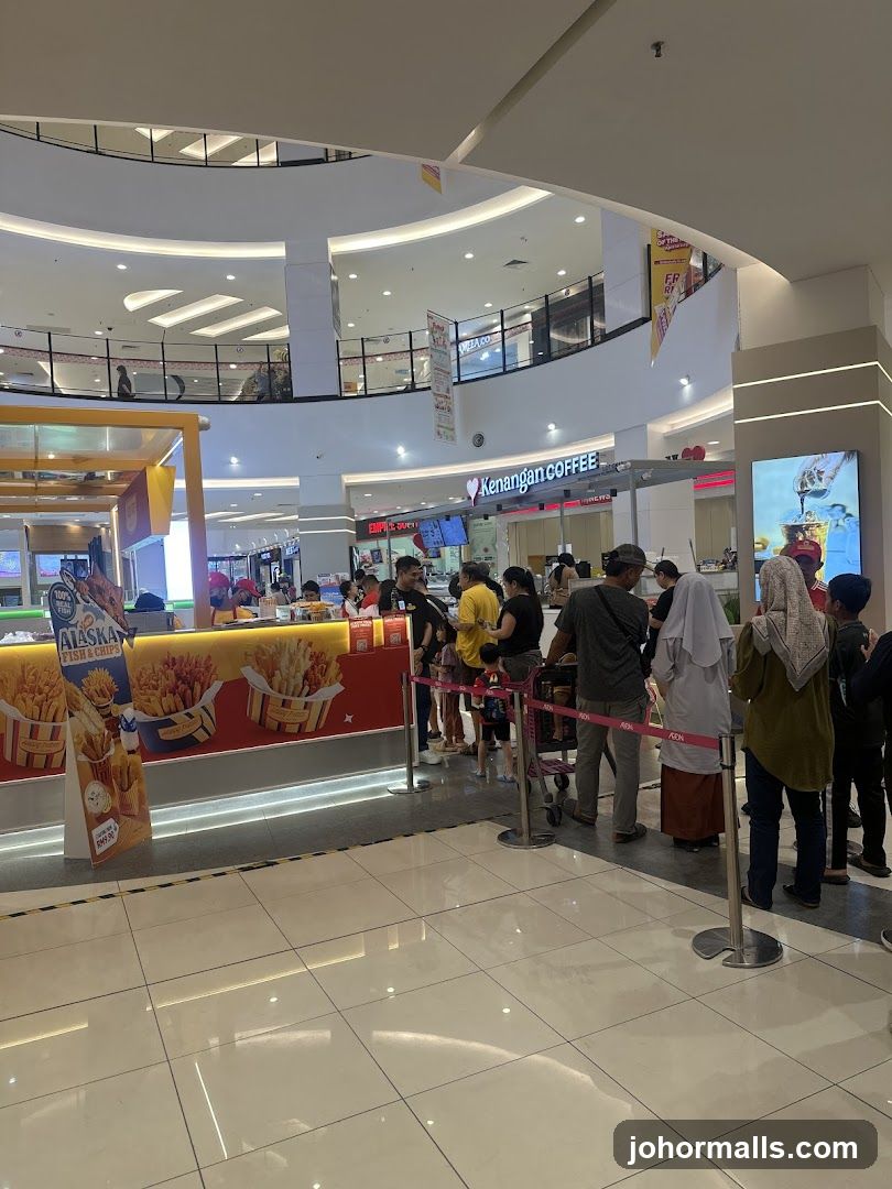 People queuing at a food stall in a mall