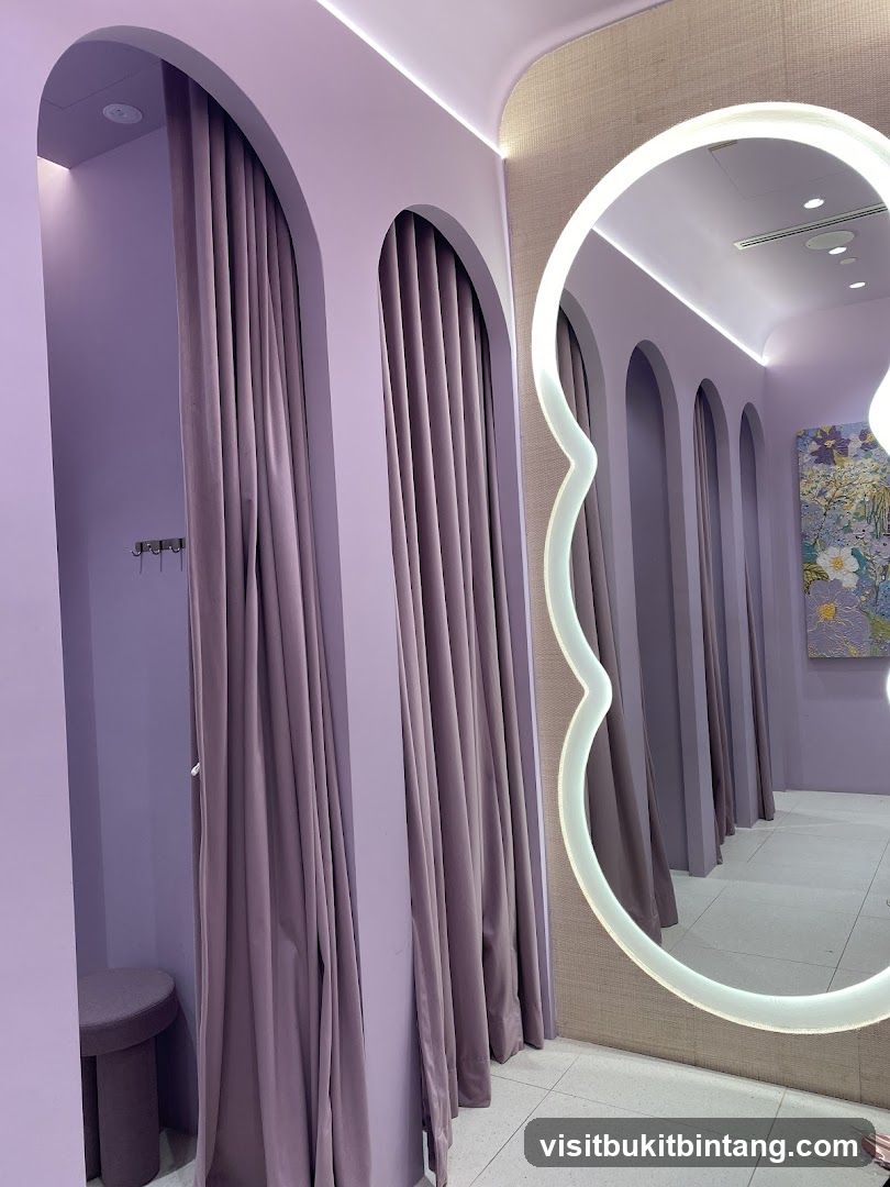 Fitting rooms with purple curtains and a decorative mirror