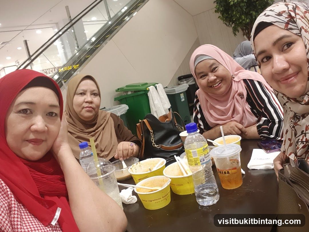 Four women at a table with food