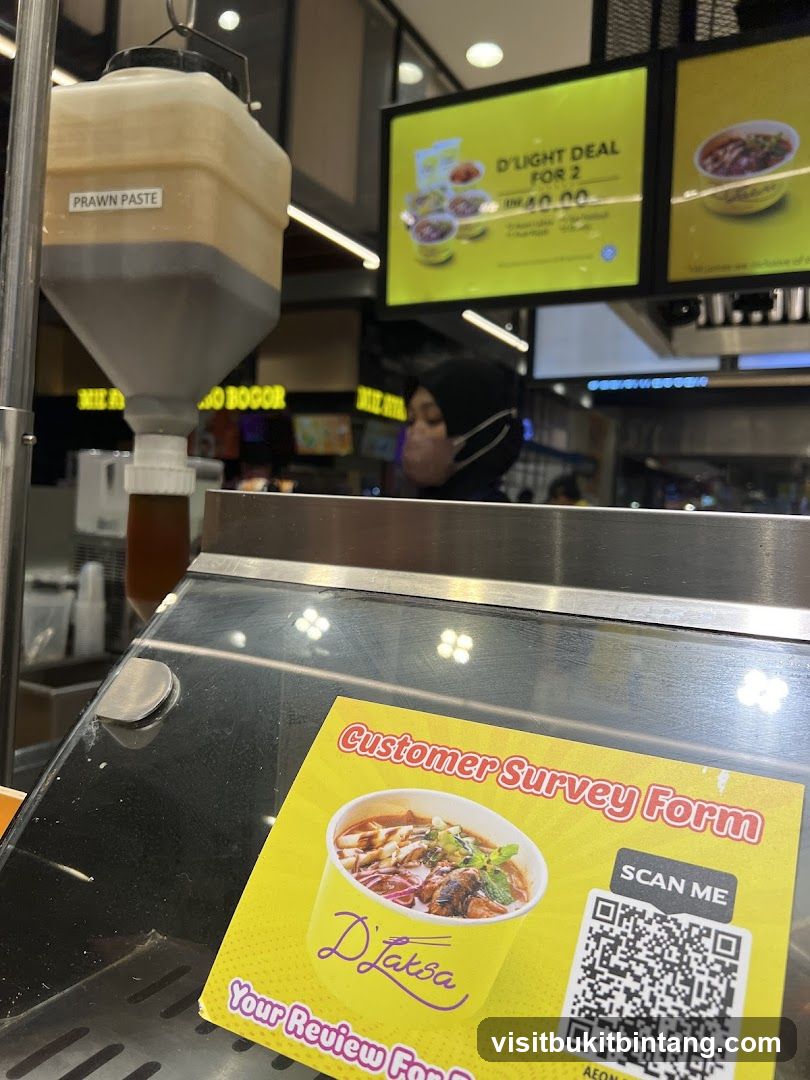Food stall with prawn paste dispenser and promotional sign