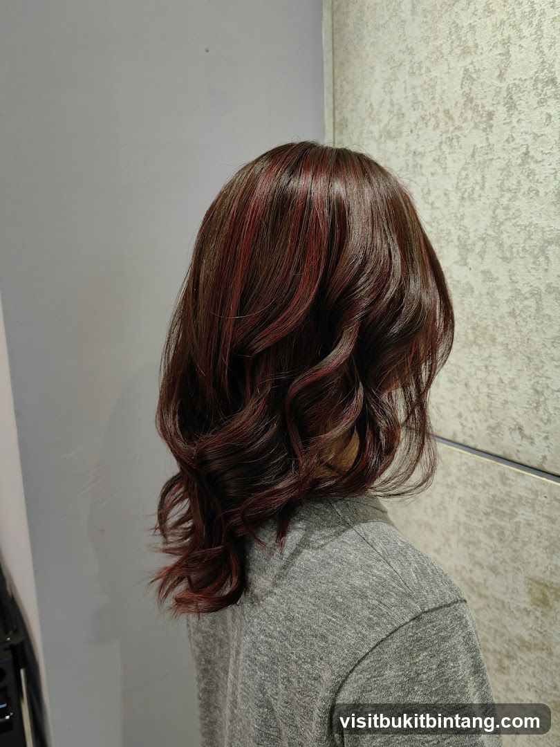 Woman with styled dark hair with red highlights