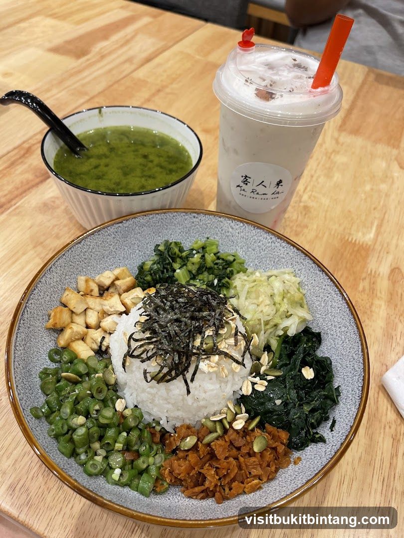 Rice bowl with various toppings and a drink