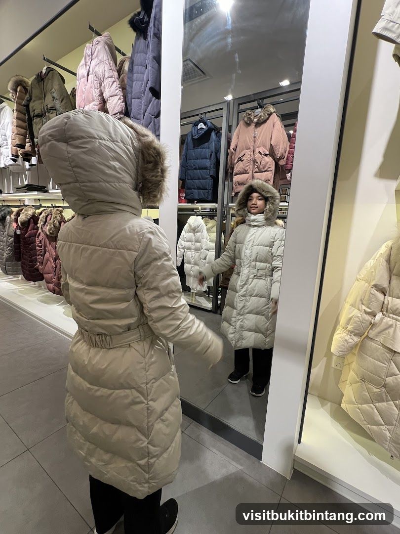 Woman and child trying on winter coats in a store