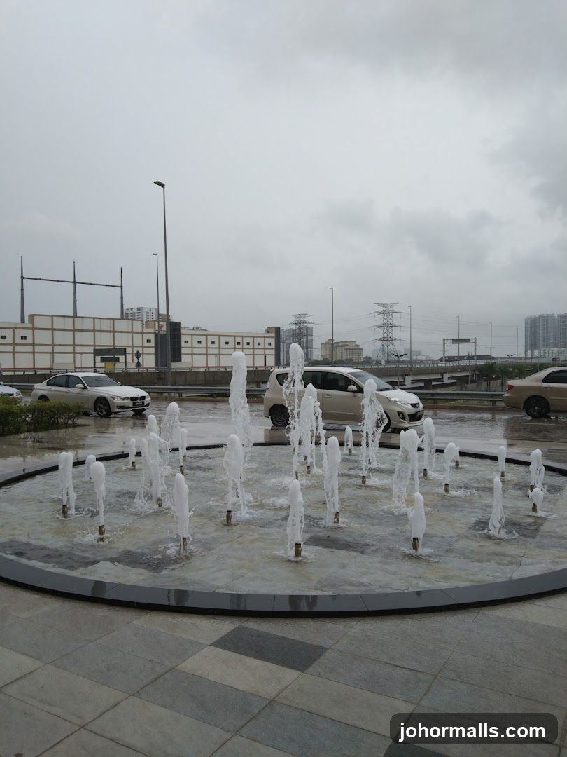 Outdoor Fountain with Cars and Buildings