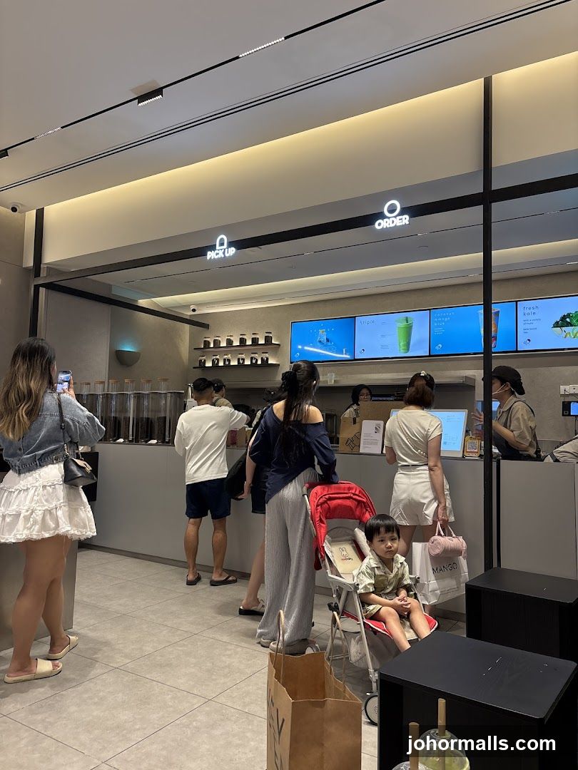 People ordering and waiting at a beverage shop